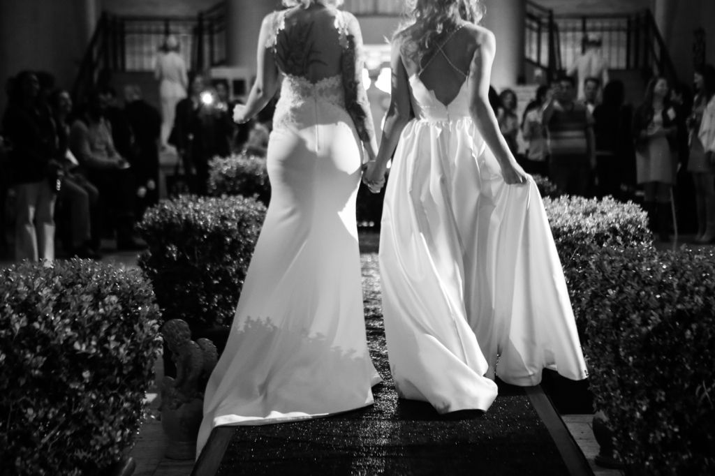 Two bride models walking on runway for gay vanity wedding show