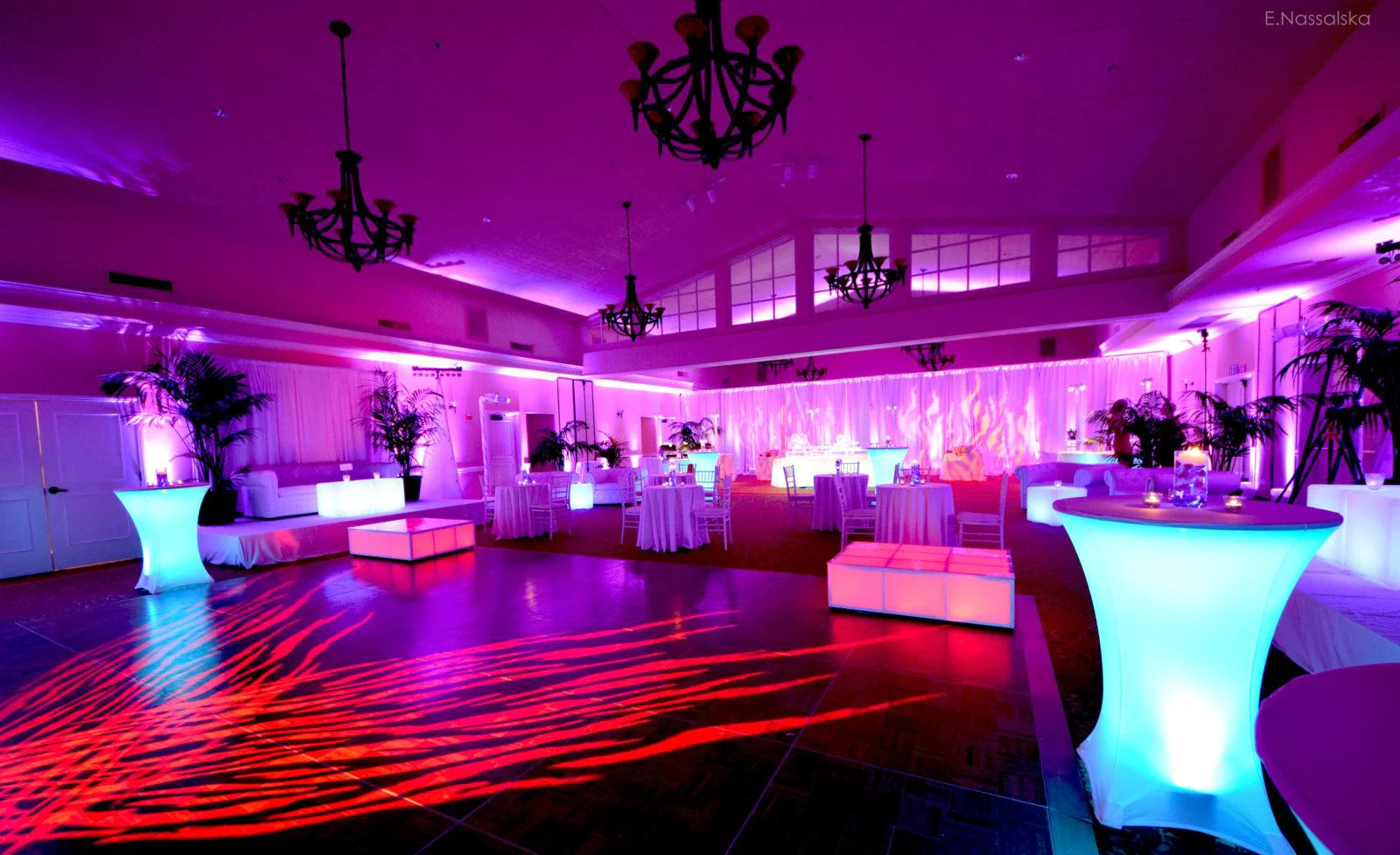 Multicolored venue lighting and red pattern wash dance floor lighting