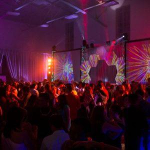 Stage and dance floor lighting with digital screens and projector set-up for corporate event