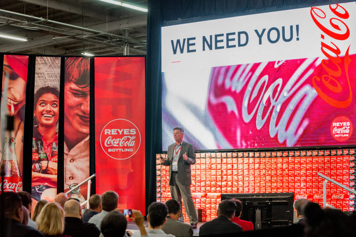 Stage lighting and digital screen background for corporate event