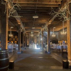 Indoor chandelier and up lighting for dining set-up in winery
